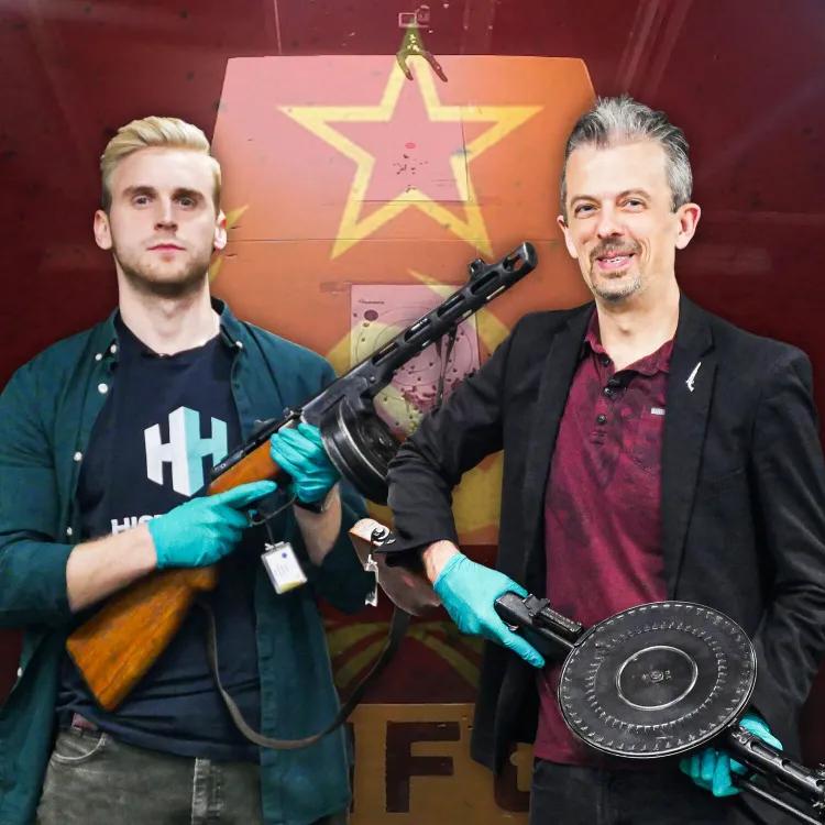 Jonathan Ferguson and Luke Tomes holding firearms with Russian USSR flag behind