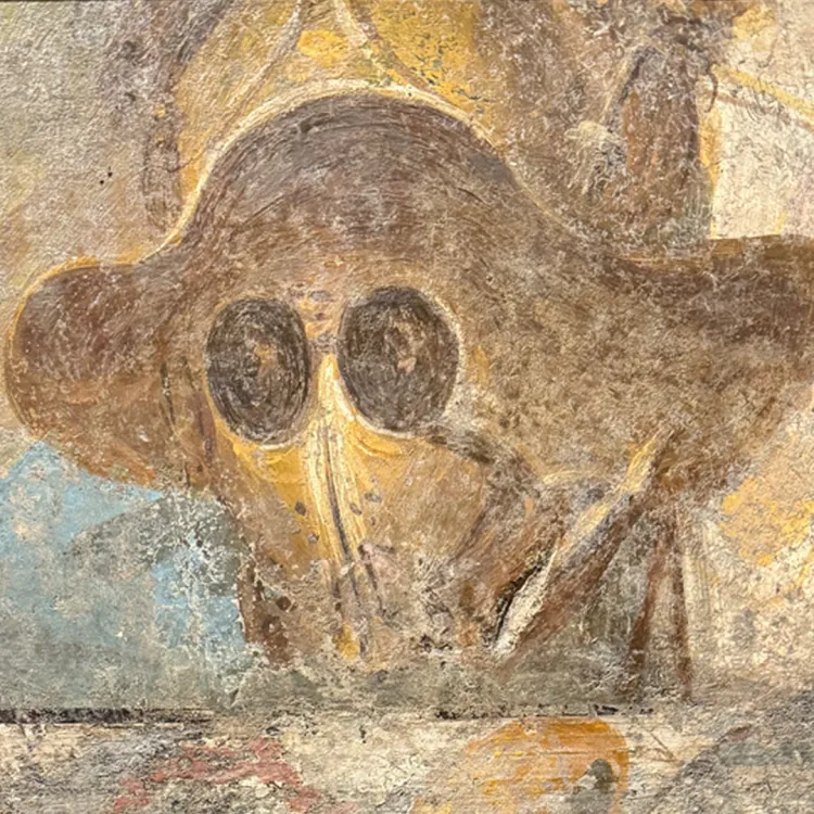 A Roman fresco of a broad brimmed helmet in bronze and dark eyeholes
