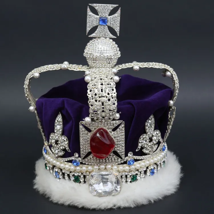 A jewelled crown in white gold with a cross atop, rimmed in purple velvet and white ermine