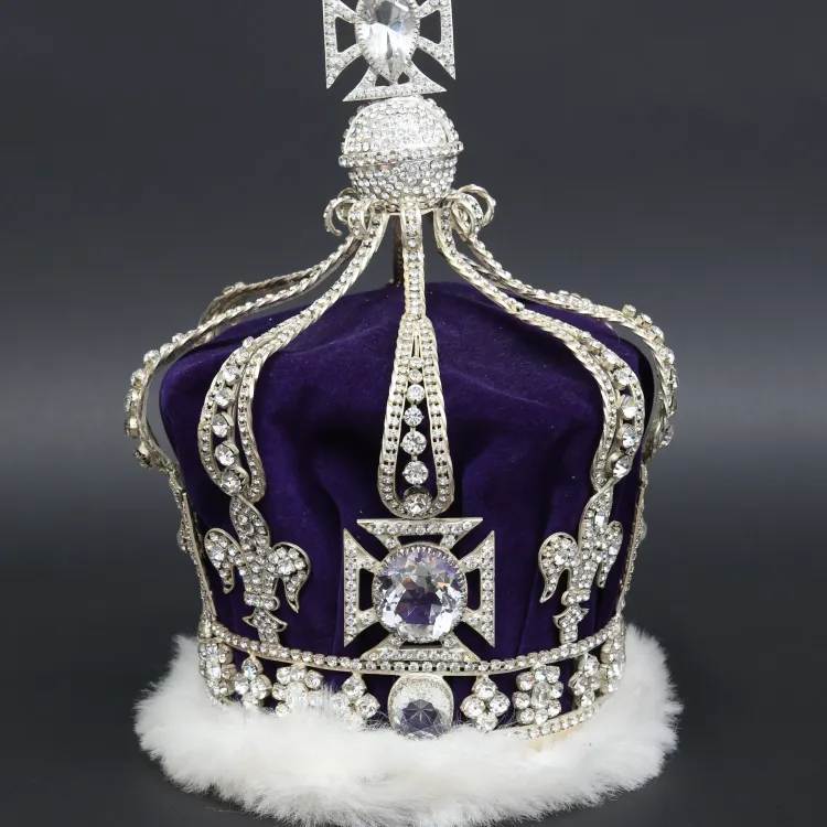 A silvered crown with white fur and purple velvet
