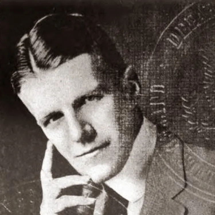 A black and white photo of a man in Edwardian suit and tie with starched collar leaning on one elbow.
