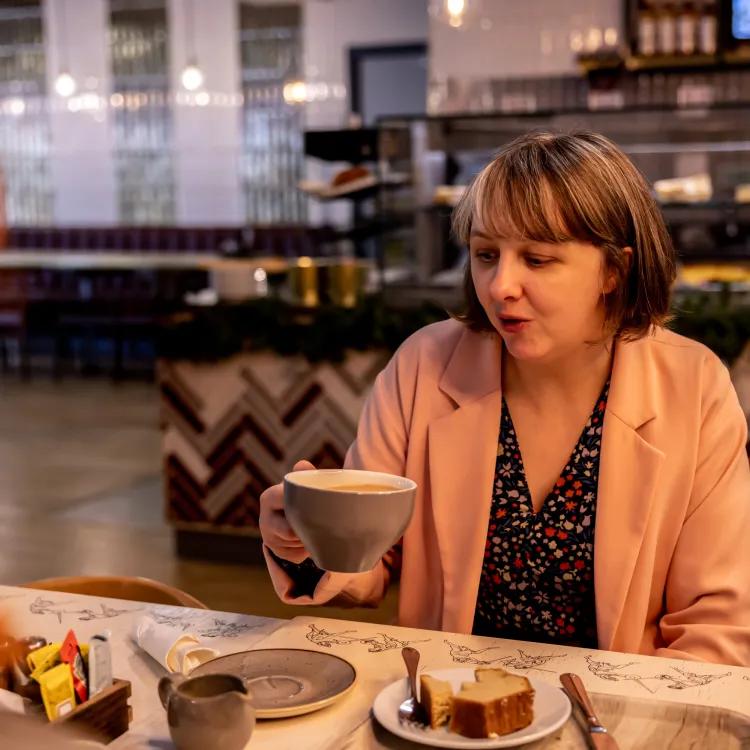 Two visitors having coffee in The Masters café