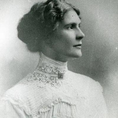 A photograph of a respectable young woman in profile who gazes proudly into the distance with a determined look and a glint of humour