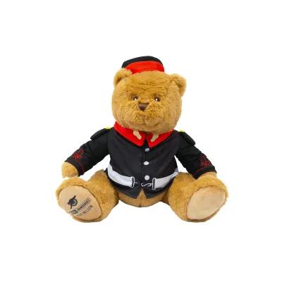 Teddy bear dressed in a blue military uniform with a hat