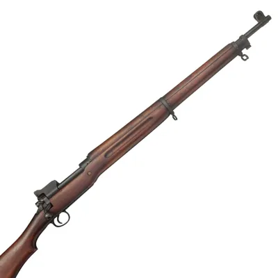 Long barrelled rifle in wood and metal with hand groove carved into the side