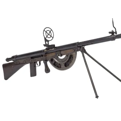 A thin barrelled machine rifle with wide optical sights and curved magazine attached on the underside