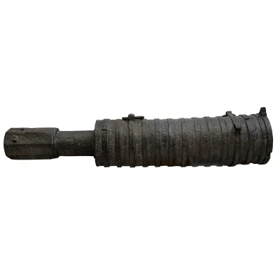 Wrought iron cannon with barrel bound by series of hoops