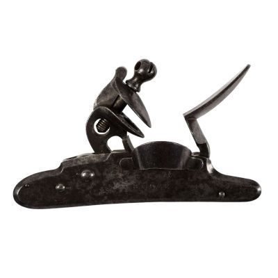 A detached lock from a flintlock musket, completely of steel