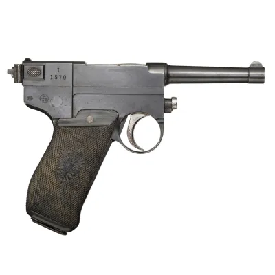 A bulky metal gun frame with a wooden stock and a small metal barrel protruding forward