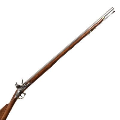 A round, long barrelled musket with a brass nose cap, rounder brass side plate and buttplate.