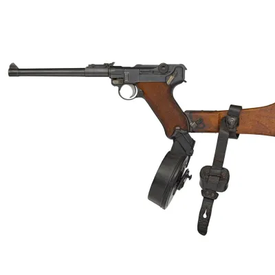 A long barrelled pistol with a drum magazine and wooden buttstock attached