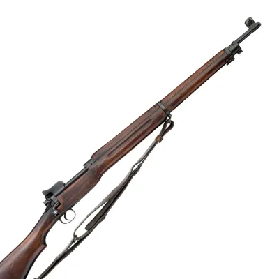A long barrelled rifle in dark brown wood and metal with a canvas sling attached