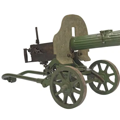 A green Maxim machine gun supported on a wheeled mount 