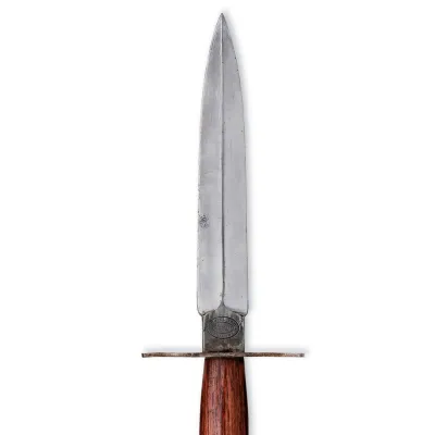 A leaf shaped knife blade with a simple cross guard and reddish wooden hilt