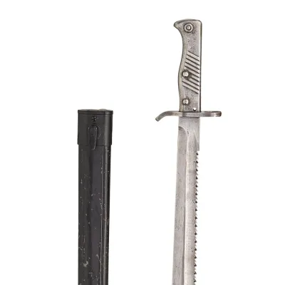 A steel saw-toothed bayonet with simple cross guard and metal hilt, and simple black scabbard