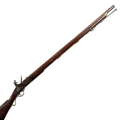 A long barrelled musket with brass buttplate, finished in walnut wood and iron.