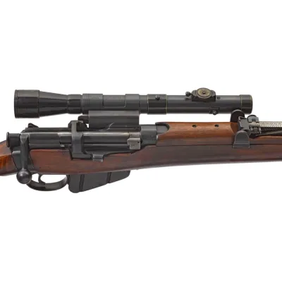 An aiming scope attached to the top of a wood and steel rifle