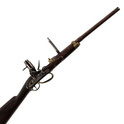A short carbine with slim barrel, a belt loop, a breech loading firing mechanism, and raised sights