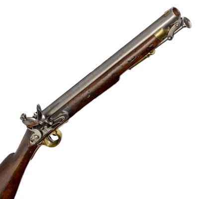 A short barrelled carbine in wood and steel, with brass trim over the trigger guard and ramrod hold