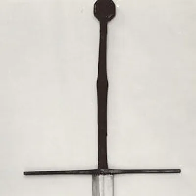 Steel hilted sword with long straight cross guard, octagonal pommel and inlaid symbols of a wolf, a fleur-de-lys, and the letter M.