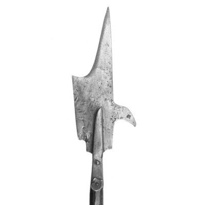 A wide metal cleaver-like blade curving to a point on top and a hook-like bill on the reverse. 