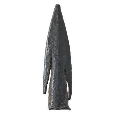 A small, compact arrowhead with tapering socket for arrow shaft and close fitting barbs. One barb is broken. 