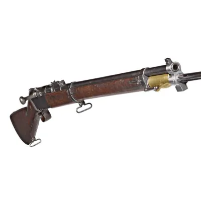 A long barrelled rifle with a steel bayonet attached to the front, both point 45 degrees towards the camera. 