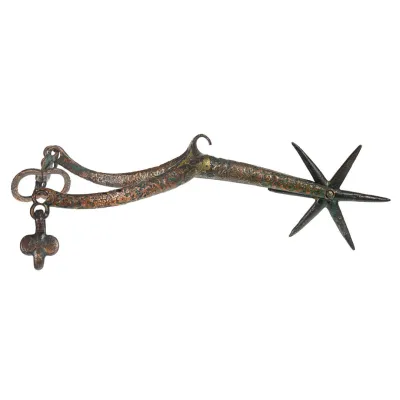 A gilded copper wish-bone shaped bar of metal, leading to a spinning six pointed star at the heel.