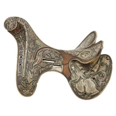 A wooden horse saddle veneered in bone. The bone is intricately decorated with natural pictorials in green, blue, and red. 