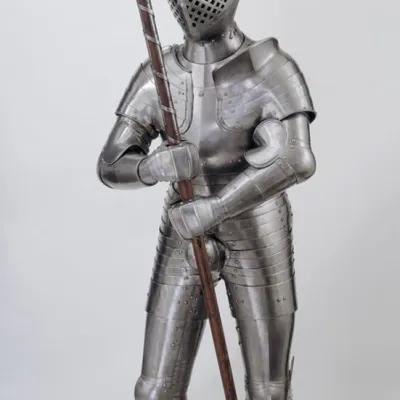 A full suit of armour holding a poleaxe 