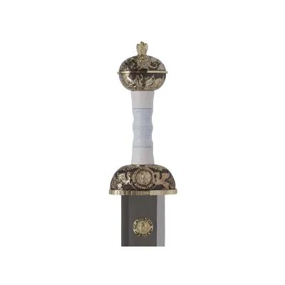 Hilt of a gladiators sword decorated in black, gold and white