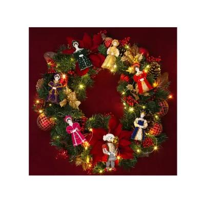 Christmas wreath adorned with seasonal foliage and lights, interspersed with small figures in historical dress representing Henry VIII and his six wives