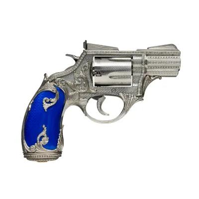 Close-up of a classic Smith & Wesson revolver displayed diagonally across a neutral background, highlighting barrel engravings and trigger mechanism