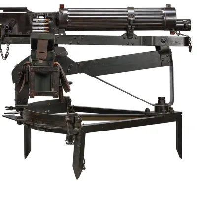 A dark coloured fluted cylindrical jacketed machine gun on a swivel-type tripod