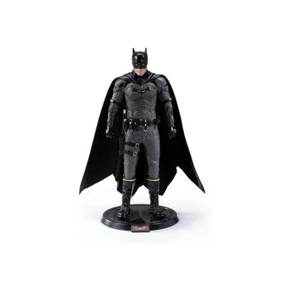 Dark grey and black Batman figure standing on a round display base, dressed in a detailed armoured suit with a flowing cape and utility belt