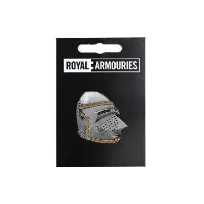 Pin badge shaped like a medieval bascinet helmet with brass-coloured trim, mounted on black card packaging labelled “Royal Armouries”