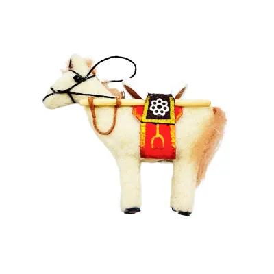 Mini felt horse ornament facing left, cream wool body with brown mane, red saddle blanket, black reins and small hanging loop