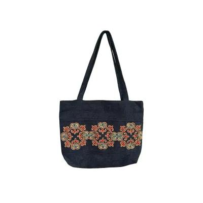 Cloth shopping bag in dark blue with decorative red and gold scroll motifs stitched in a central strip