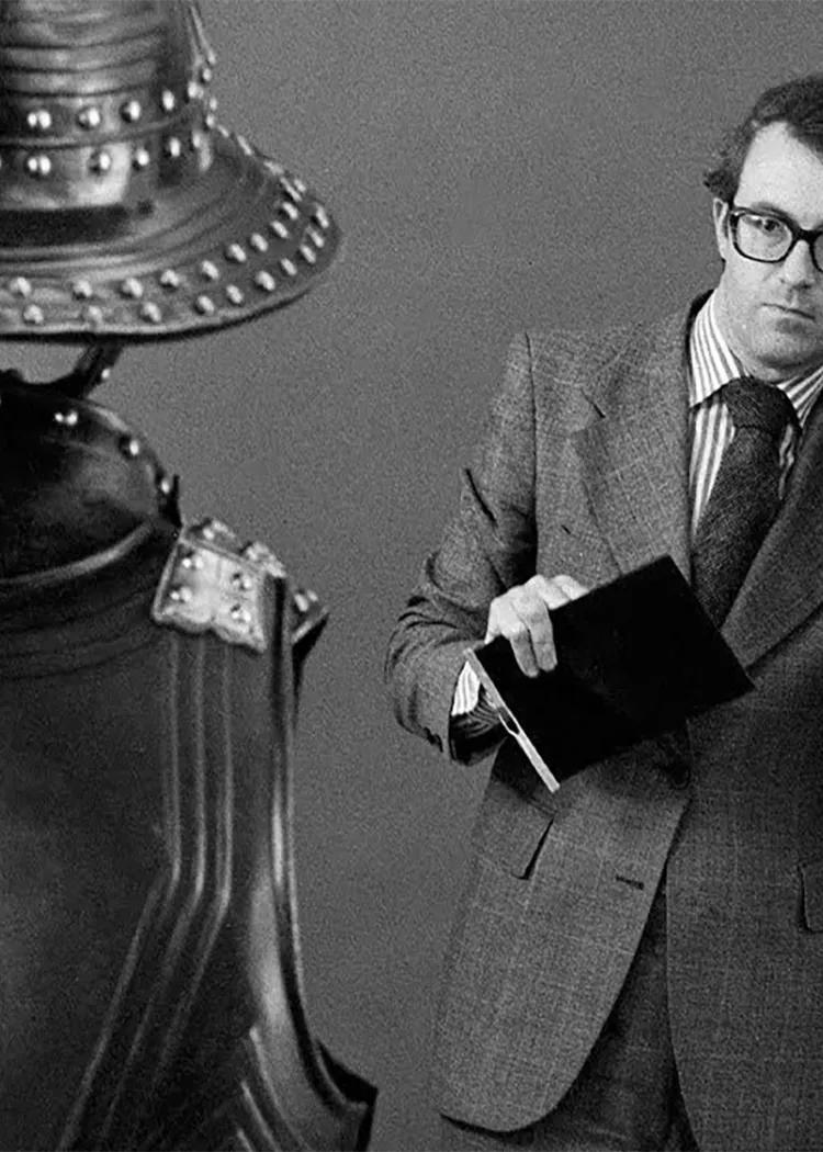 Monochrome image of Jeremy Hall photographing an English Civil War armour