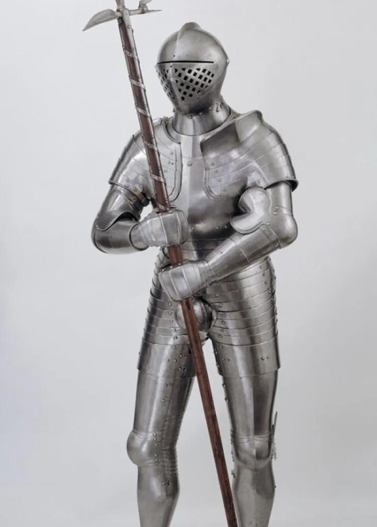 A full suit of armour holding a poleaxe 
