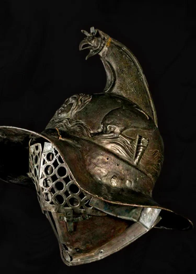 wide brimmed bronze helmet with perforated face mask and eagle crest