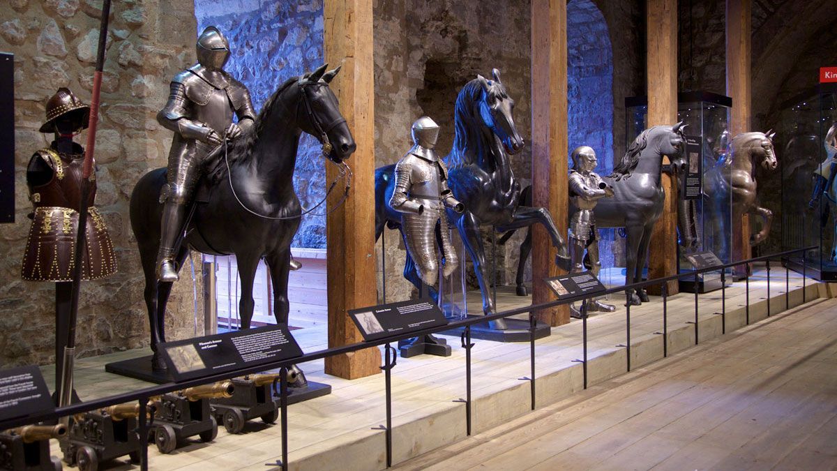 a display of steel armour and horses in a line