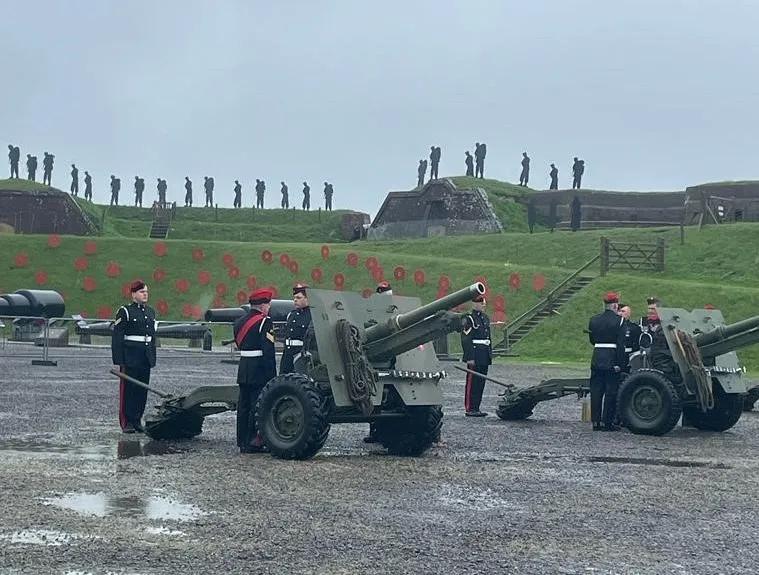 military personnel preparing to fire a gun mounted on a carriage