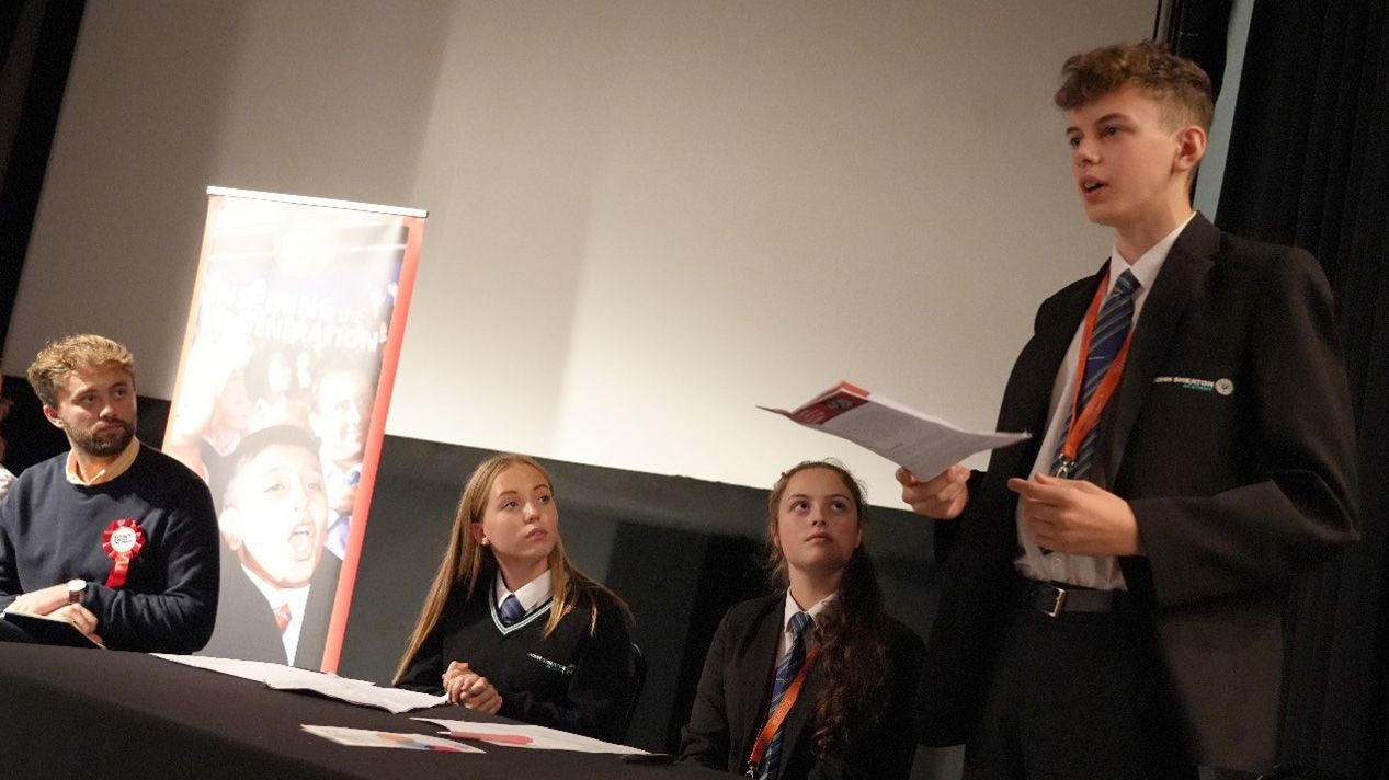 teenage school children engaged in a schools debate