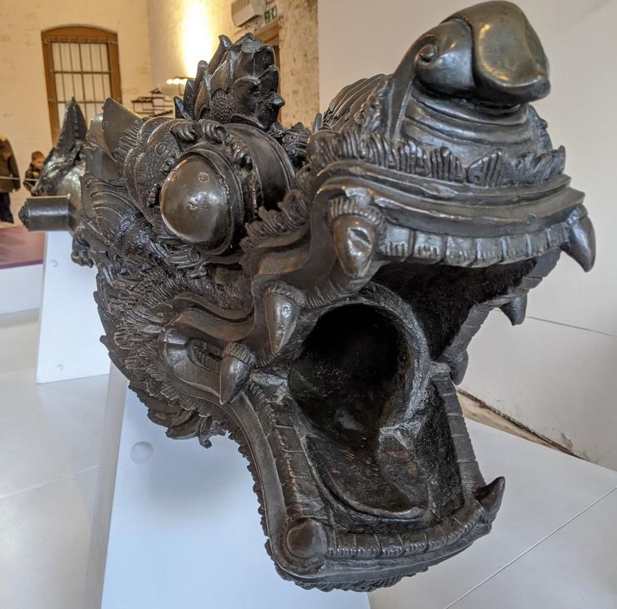 a bronze cannon cast in the form of a dragons head