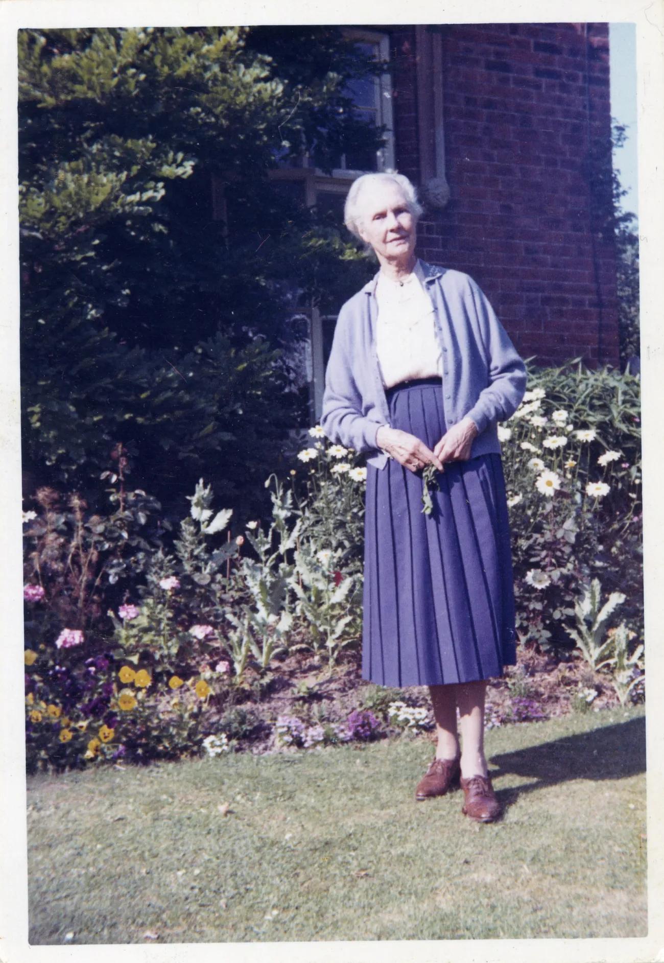 A photograph of an old woman, elegantly dressed facing forward, looking proud of her accomplishments and a life well lived 