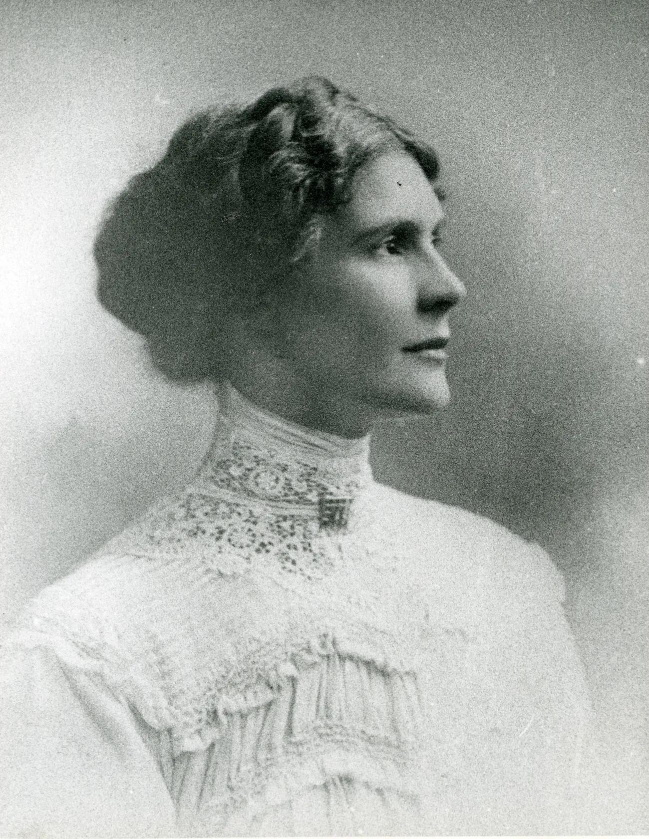 A photograph of a respectable young woman in profile who gazes proudly into the distance with a determined look and a glint of humour