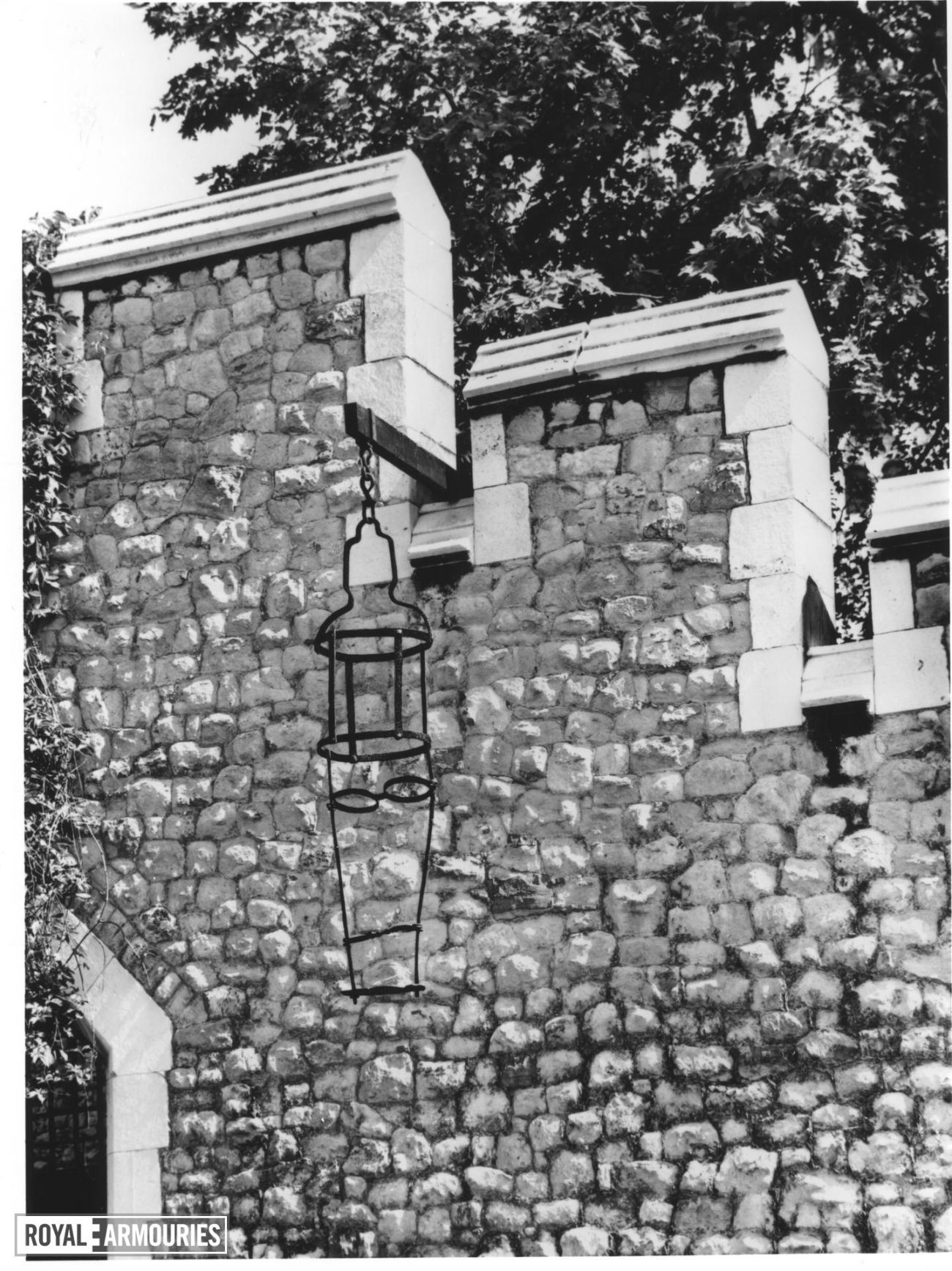 Gibbet photographed hanging off a stone wall