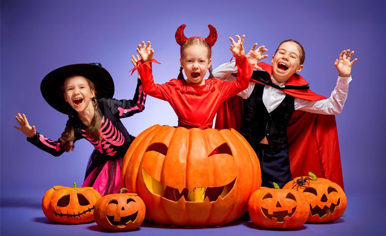 Three children dressed for a Halloween party