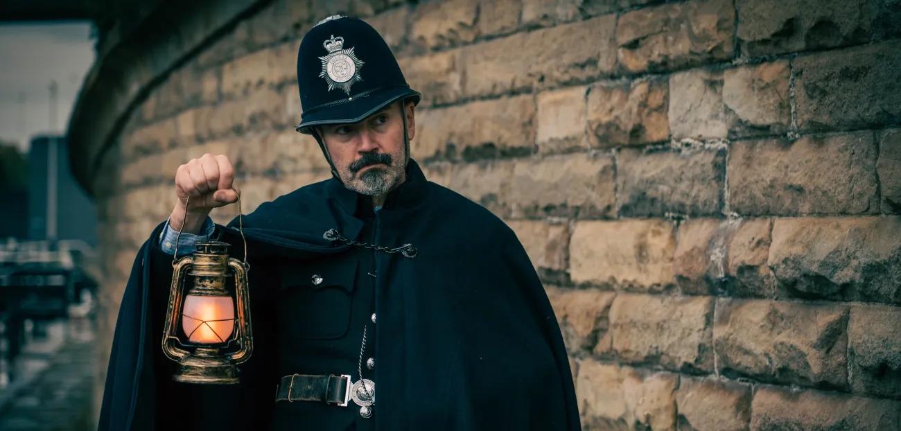 Actor in costume as Victorian police officer